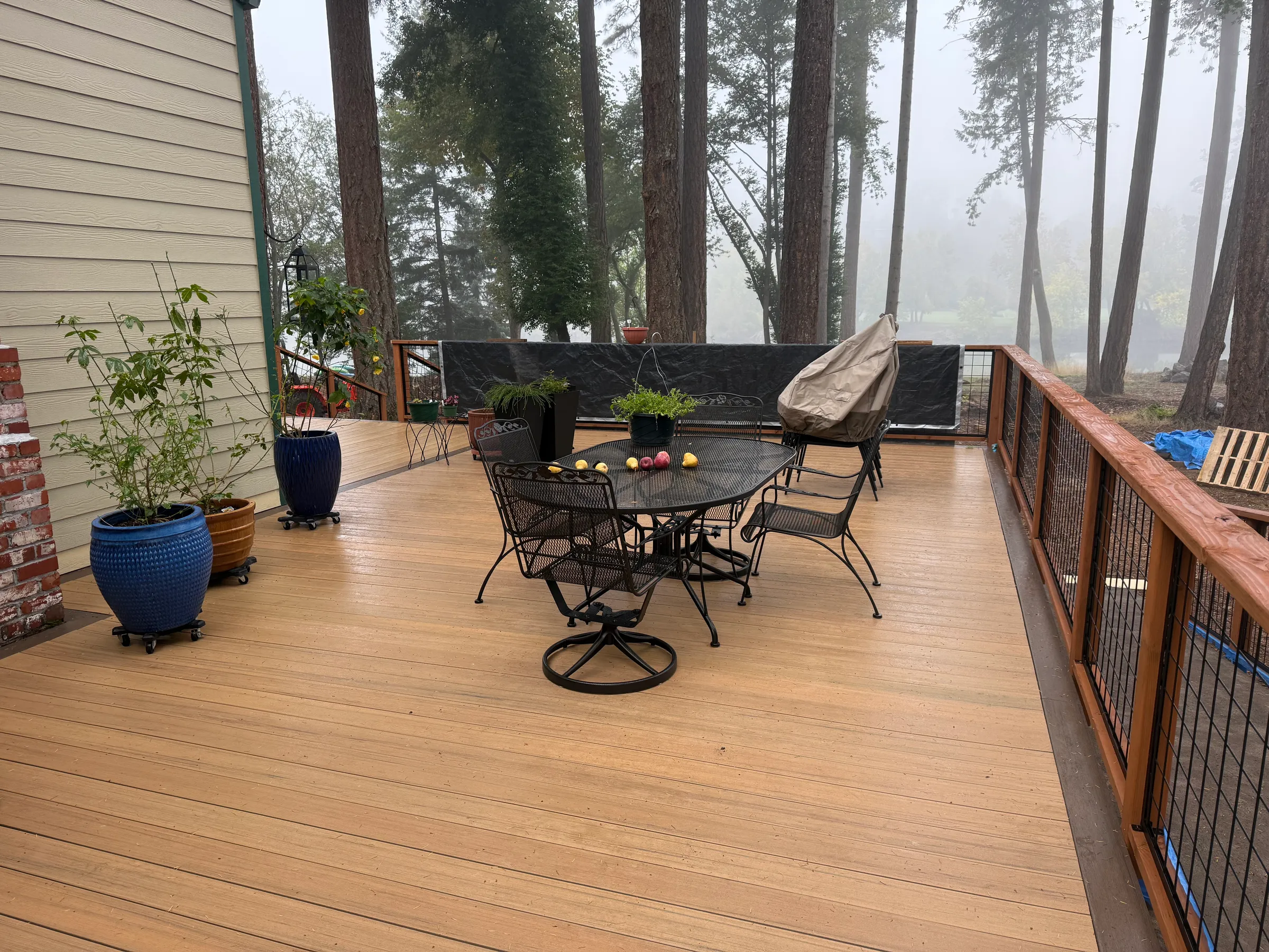 Custom deck with furniture in foggy Pacific Northwest forest