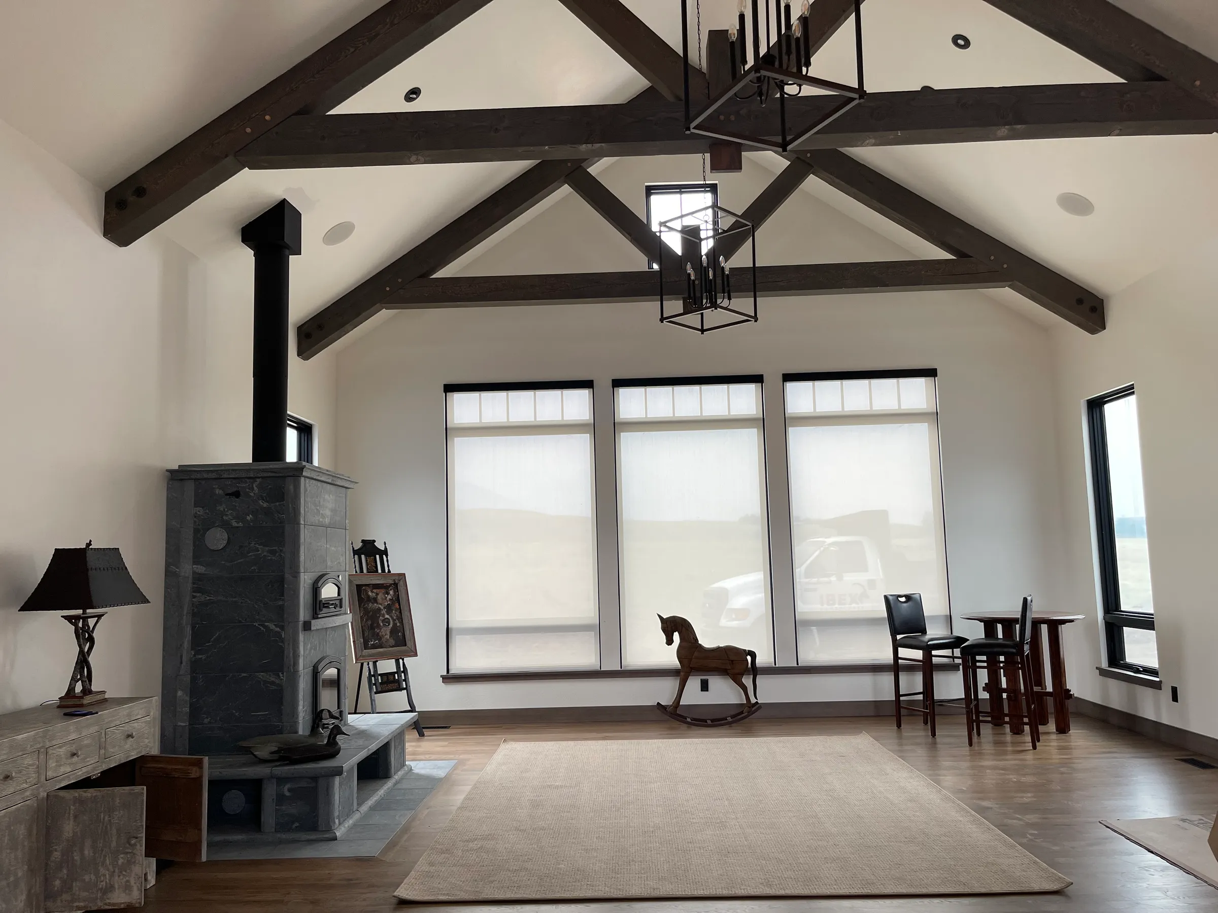 Custom great room with vaulted ceiling and timber trusses